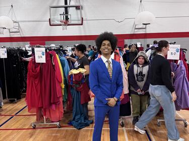 student posing with suit on 